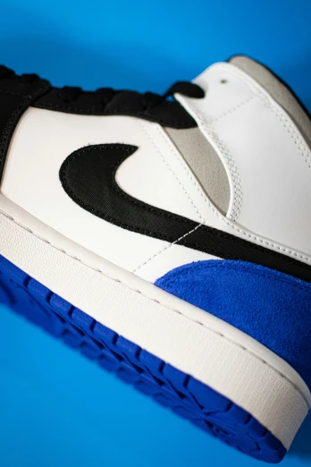 there is a blue, white and black sneaker on the ground