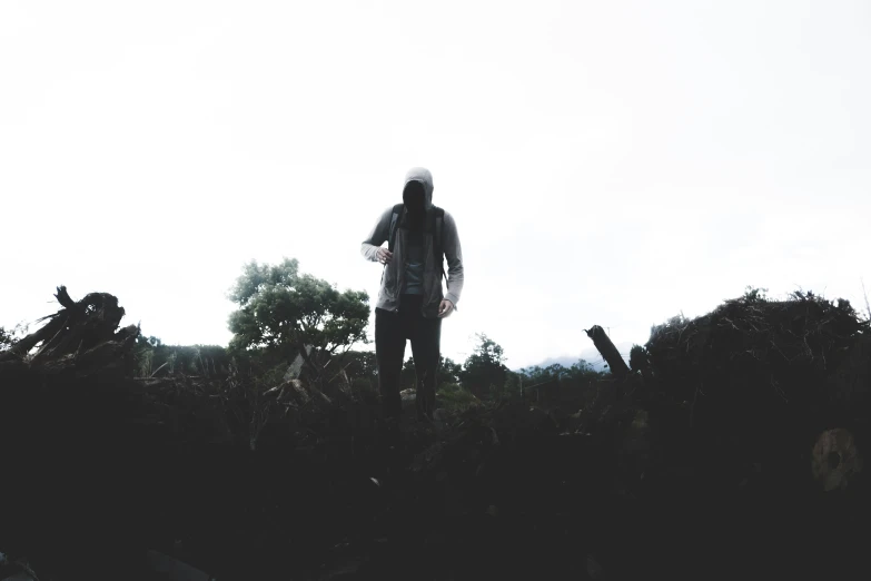 the man standing with his skateboard is facing away from camera