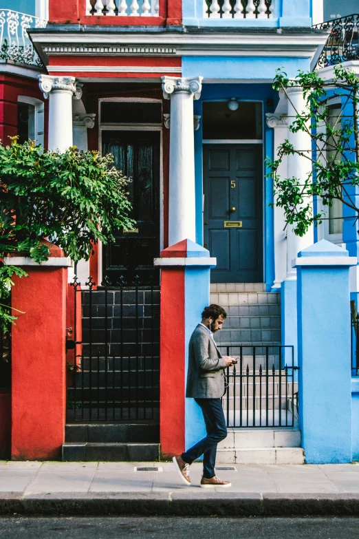 man in front of house in front of the street