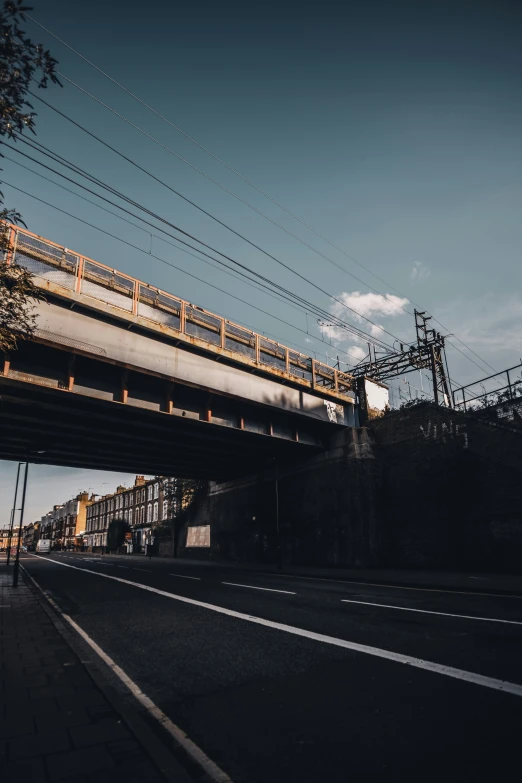 an overhead train sitting in the dark on the tracks