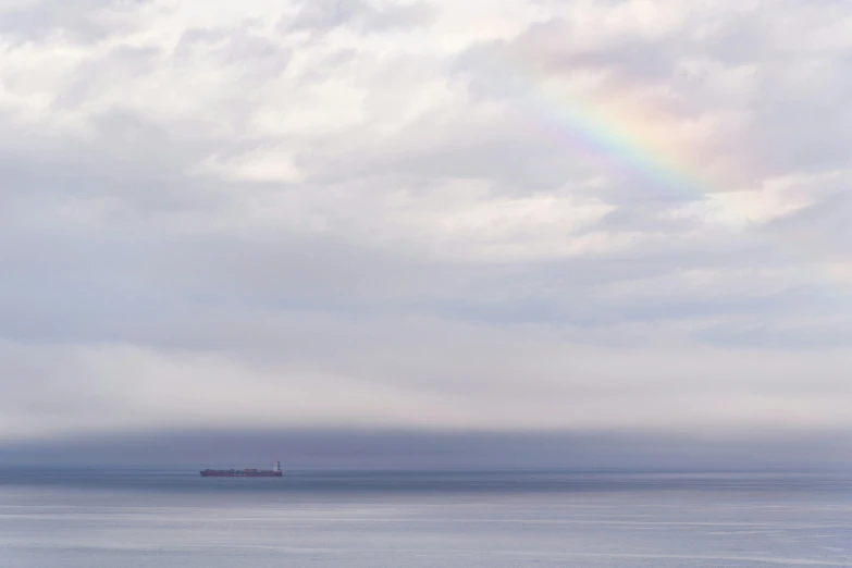 a large body of water with a rainbow on it