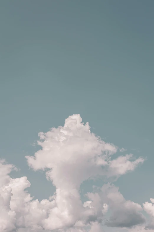 two airplanes in the sky with clouds and a blue sky behind them