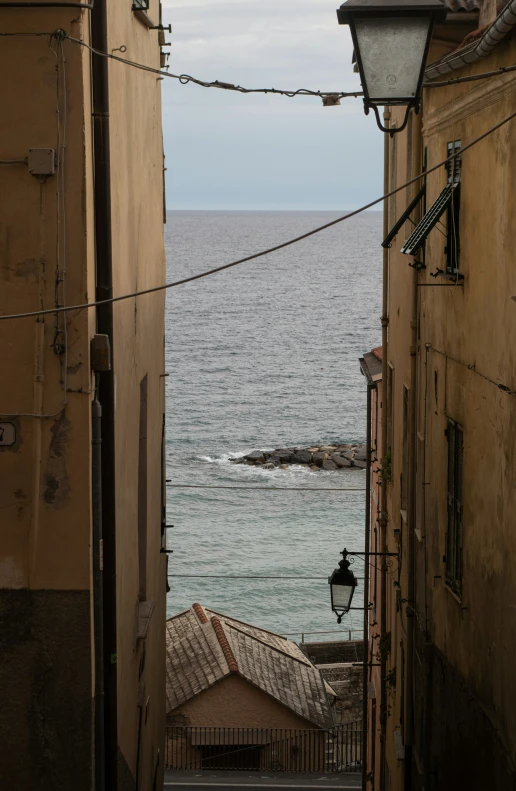 looking down a long narrow street toward the ocean