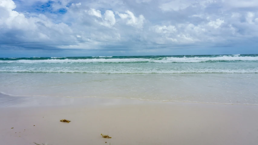 the blue and white sky has clouds over the ocean