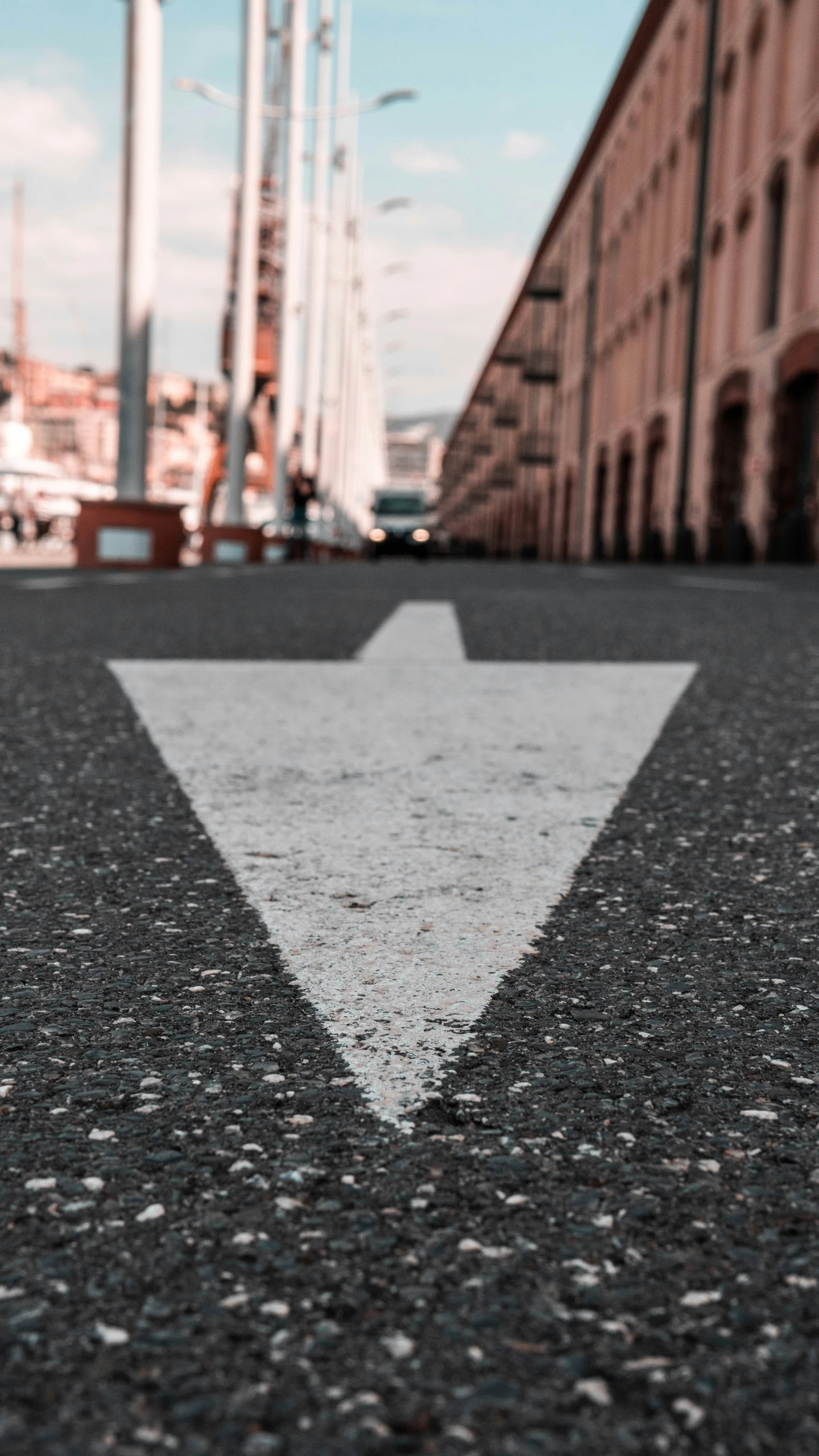 an arrow on the asphalt showing which way to go