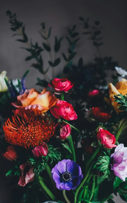 a close up of a vase of colorful flowers