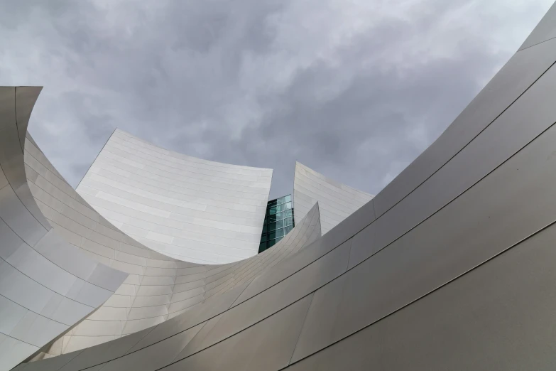 the sky and clouds are seen above this building