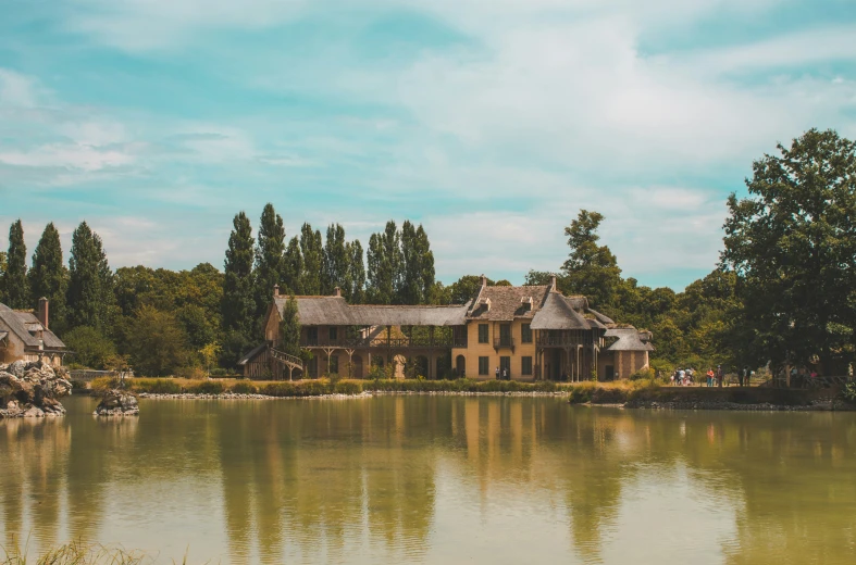 a large house sitting on the side of a lake
