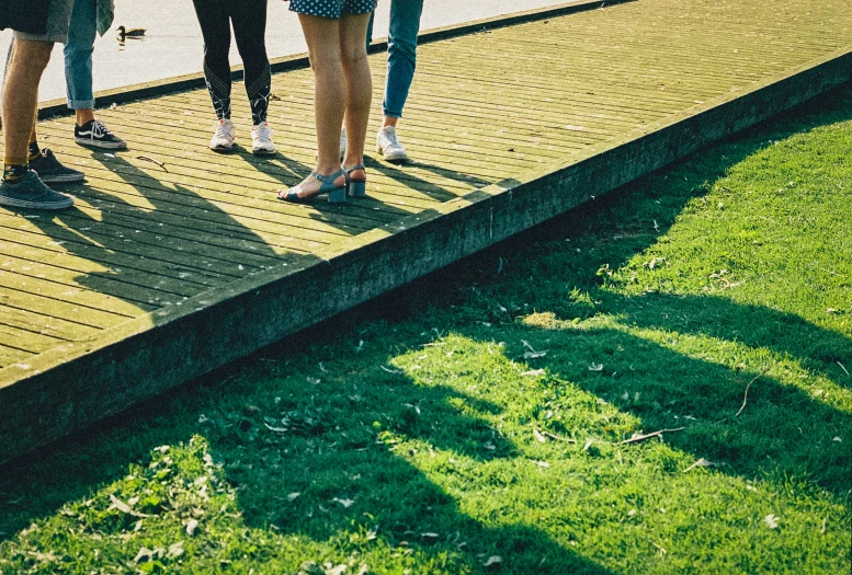 a couple of people standing on top of a pier