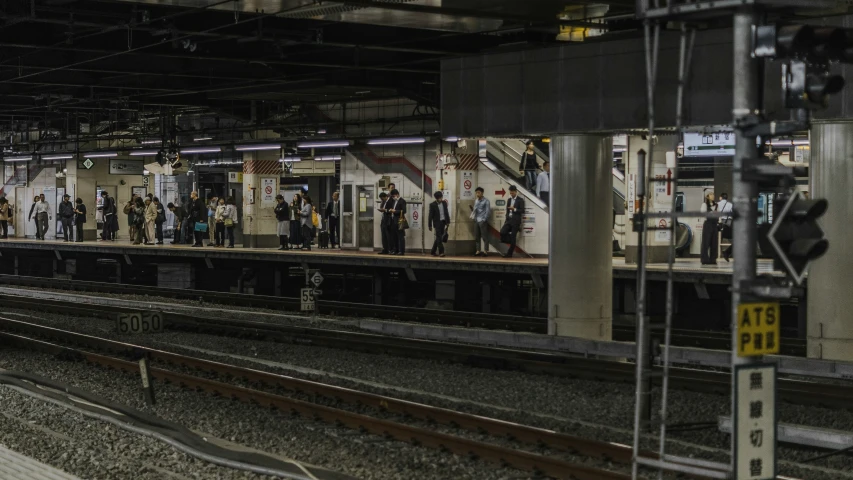 people at the platform waiting for a train