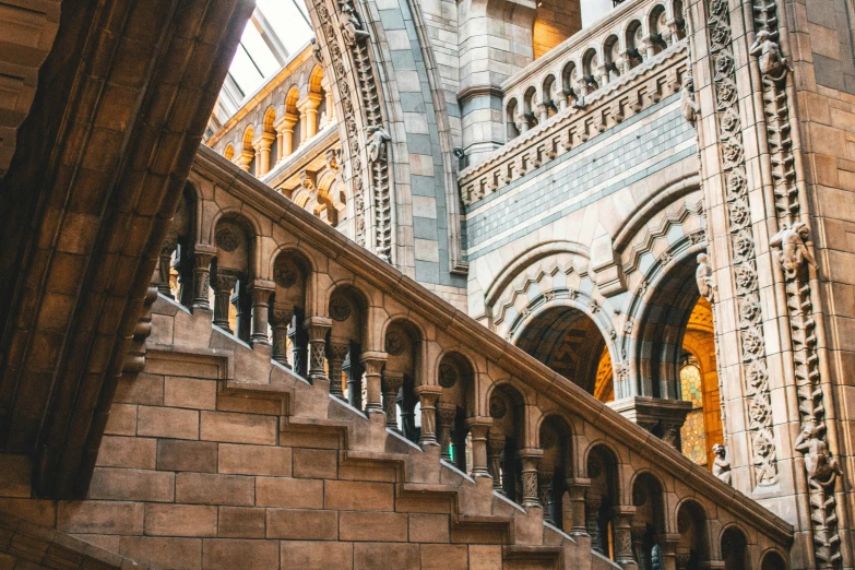 an ancient building is seen from below the stairs