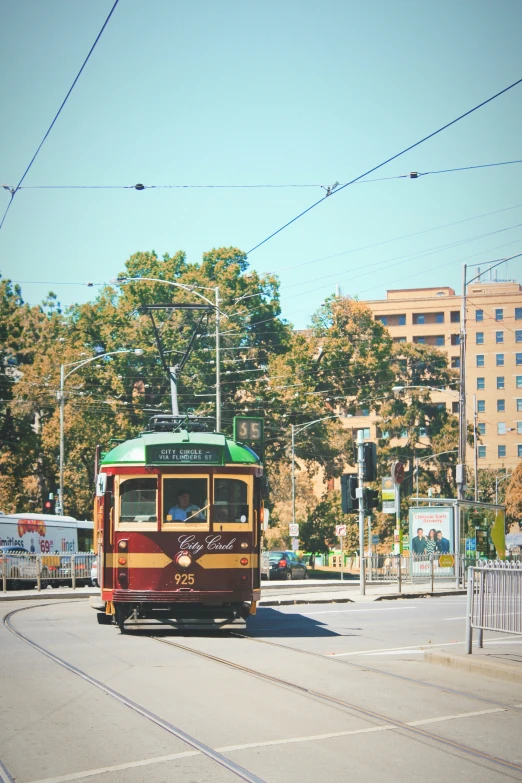 the trolley is driving down the busy road
