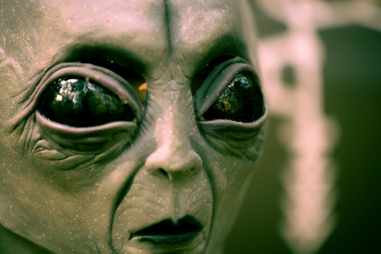 an alien looking person with eyes looking up