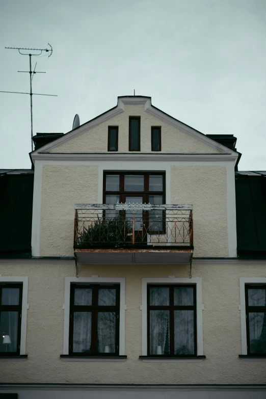 a building with balcony on the corner has a balcony garden