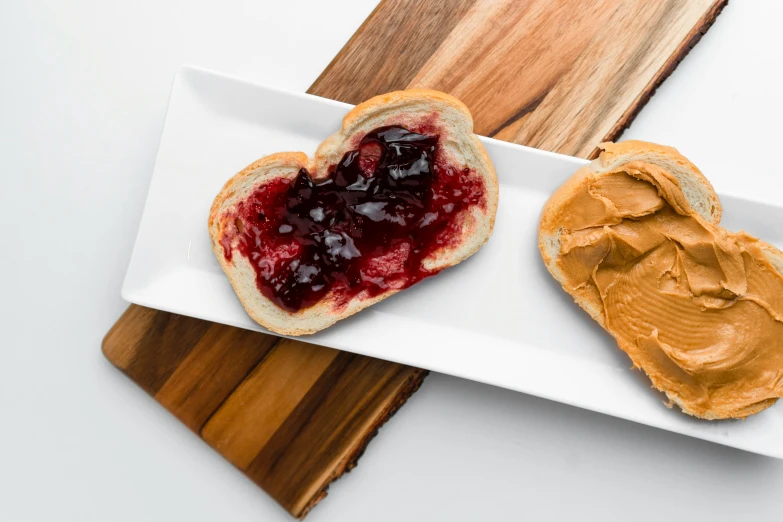 peanut er and jelly sandwiches on a white plate
