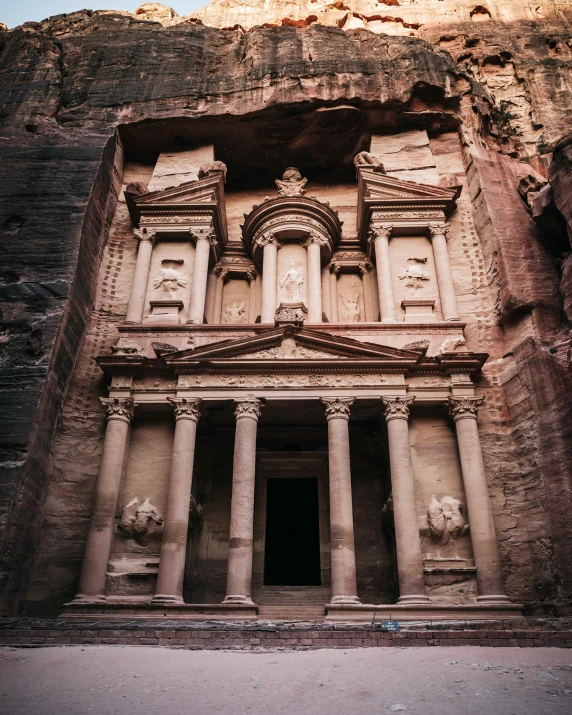 an intricate carved out stone building surrounded by rock