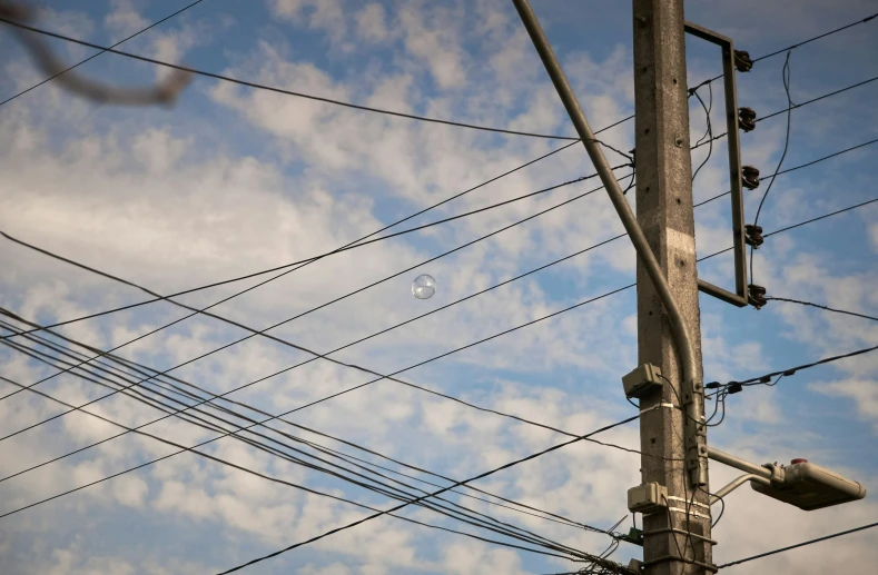 wires and wires hanging up in the air on a pole