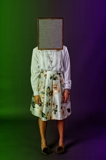 a person standing with a picture frame on their head