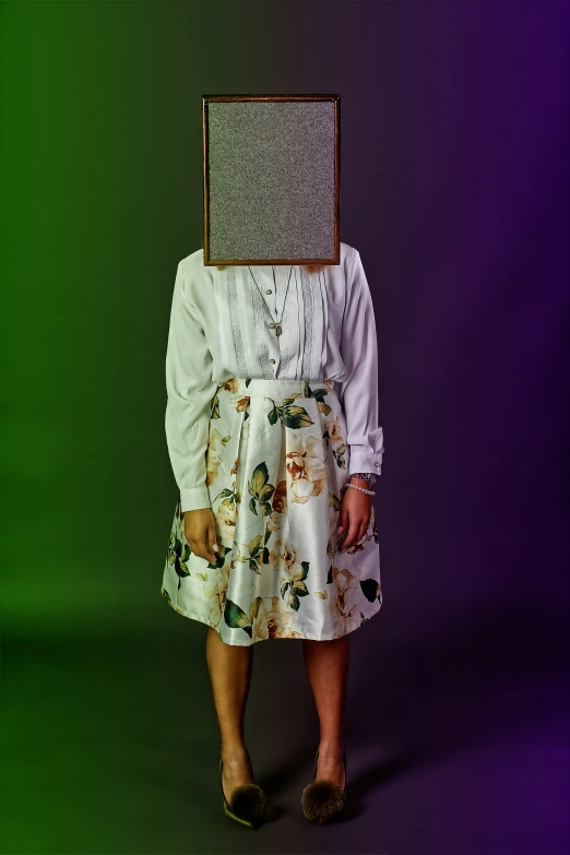 a person standing with a picture frame on their head