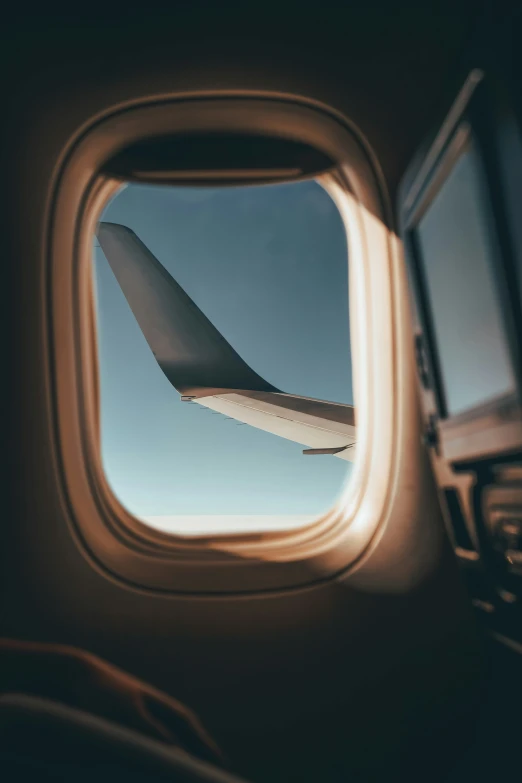 looking through a plane window at the wing