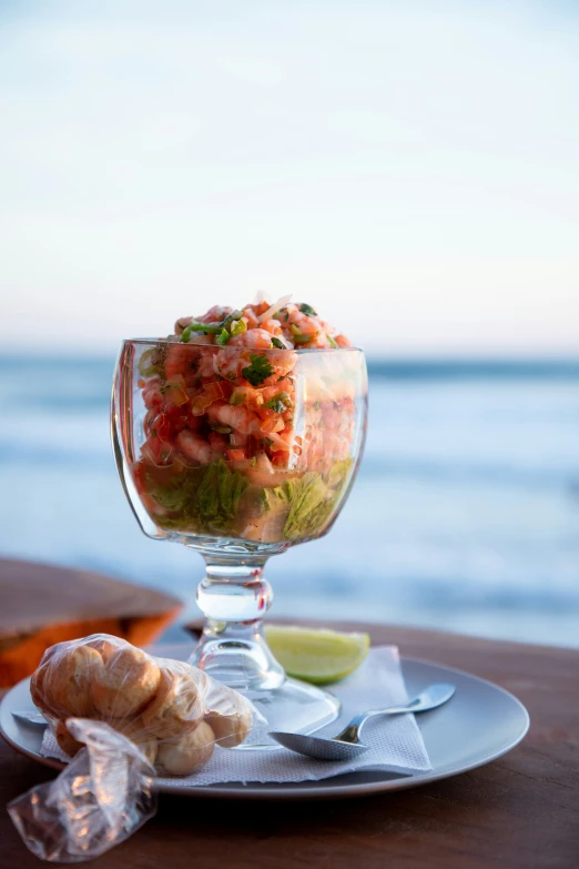 a dish is shown with chips, salsa and a lime