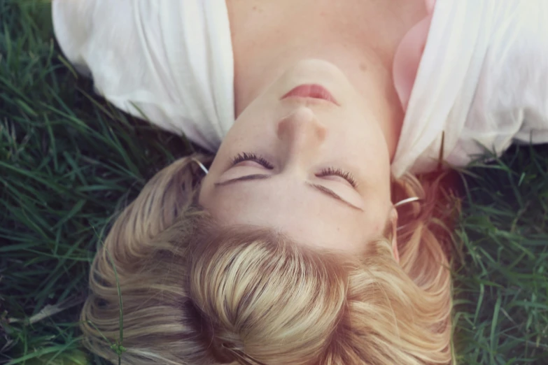 an image of woman laying on the grass