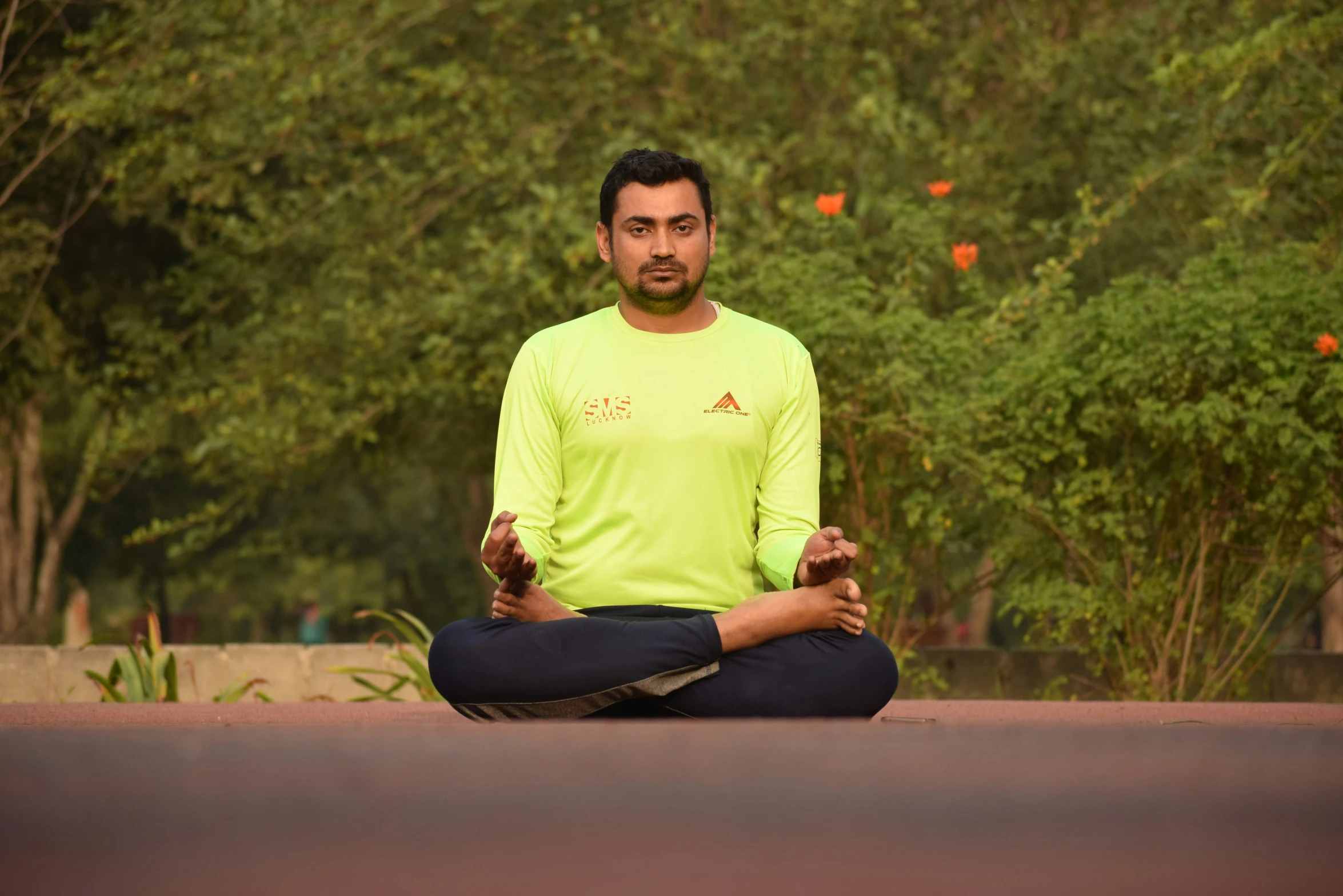 a young man in a yellow shirt doing yoga