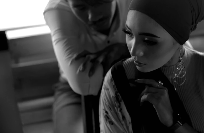 a woman with piercings is looking down while holding onto a piece of fabric