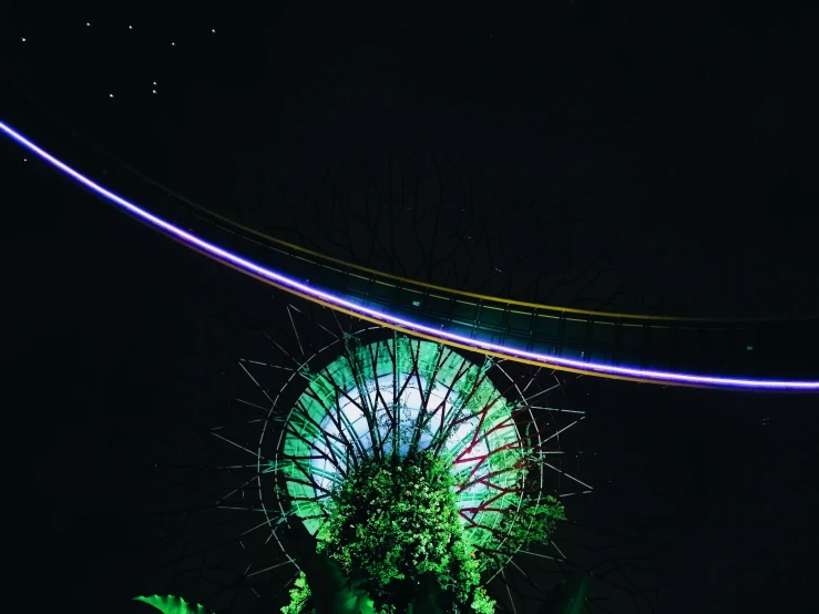 a colorful, glowing ferris wheel in the dark