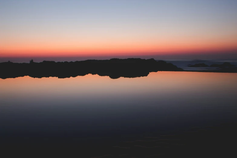 a body of water with a boat in the middle