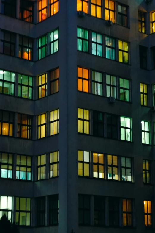 a building with brightly lit windows and lit up