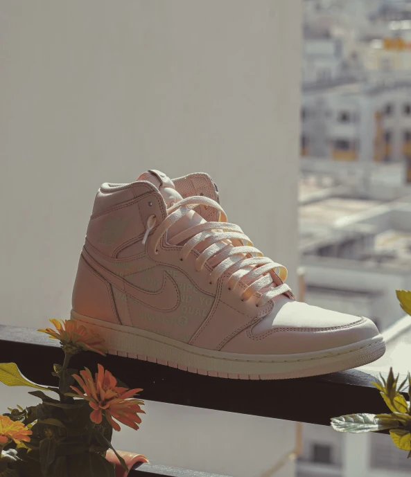 a tan pair of nike sneakers on a balcony