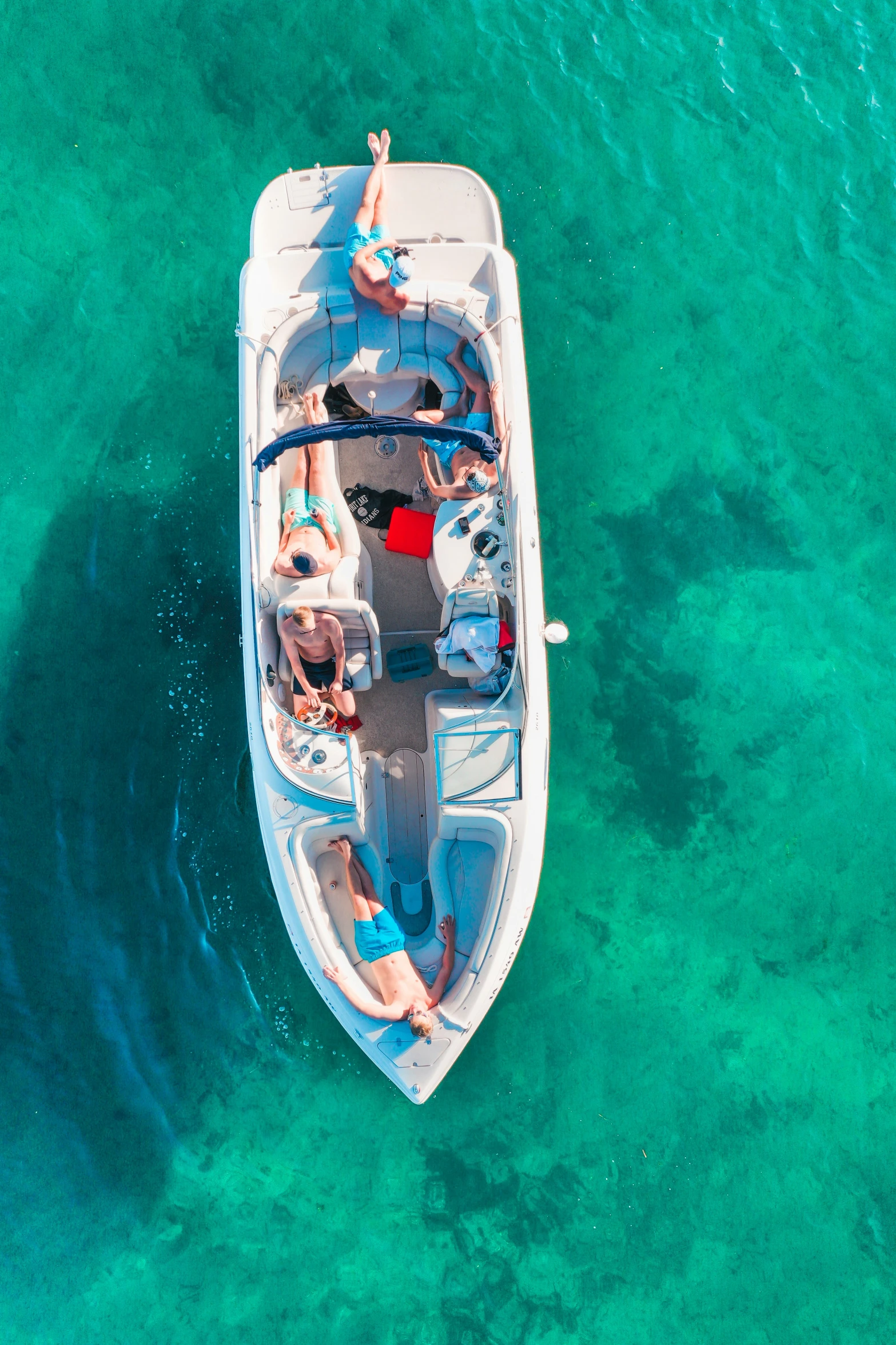 people ride in a motor boat floating near the shore