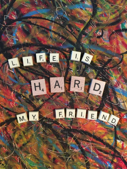 an art work with scrabble letters spelling'life is hard, my friend'and a tree