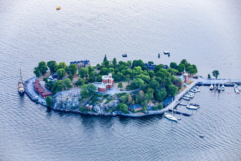 an island with several sailboats in it near the shore