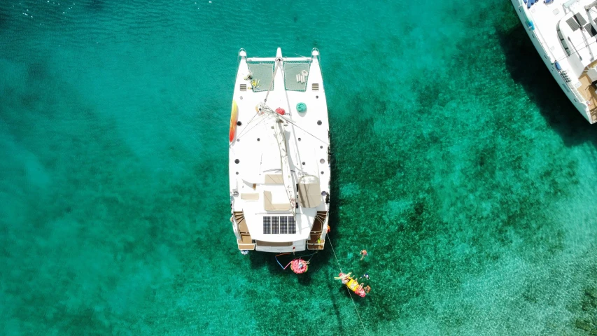 boats on a clear turquoise ocean near shore