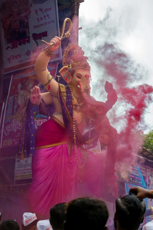 a woman in pink dancing with a large crowd of people