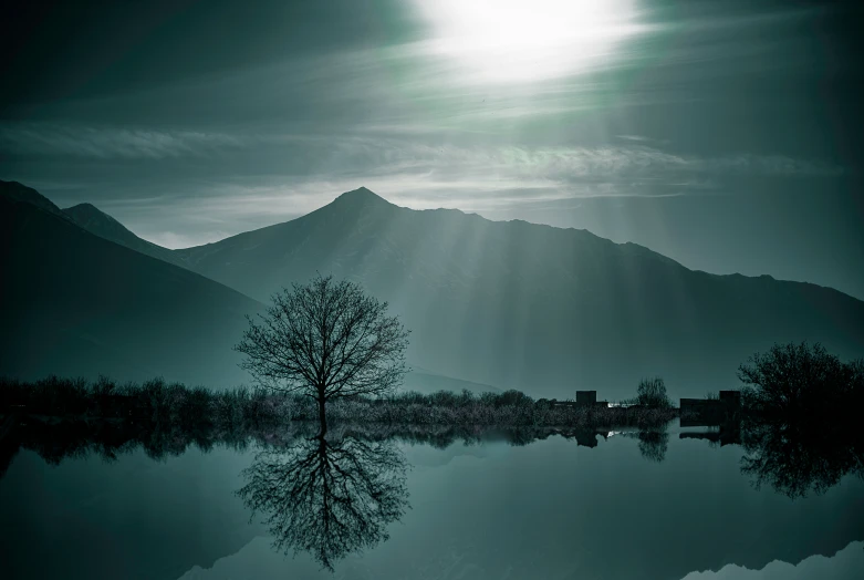 a view of the sun's rays shining over a lake