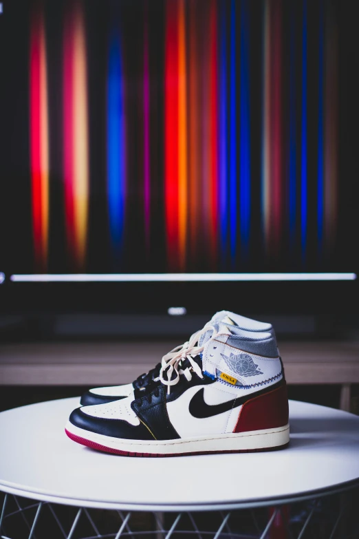 a white table topped with a pair of sneakers