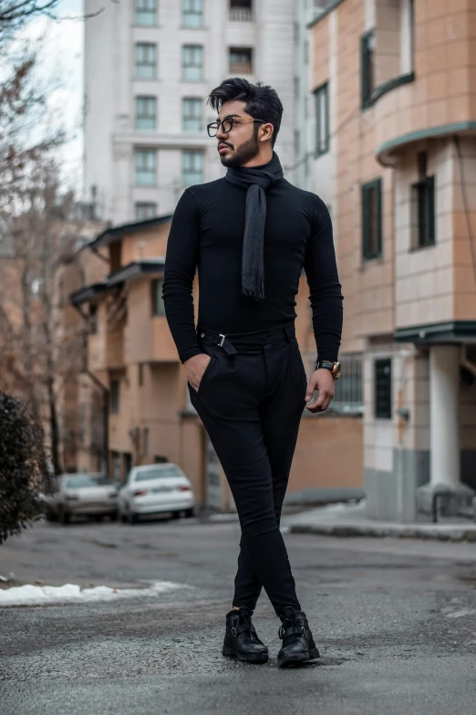a person in all black clothes posing for a picture