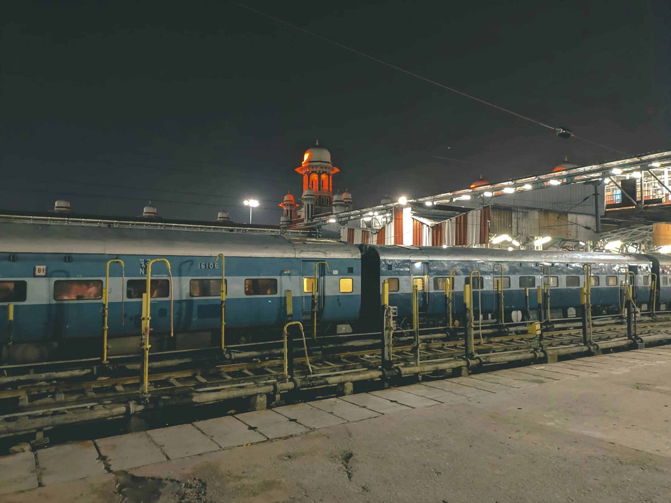 a train stopped at a train station next to its lights