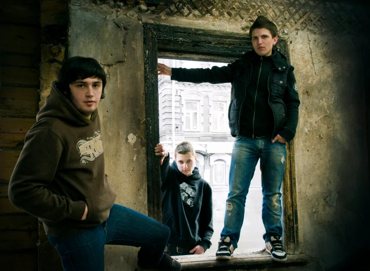 three people posing for a po in an old run down building