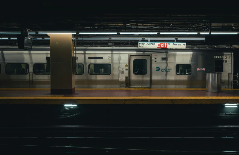 an empty subway station in a dark and empty station