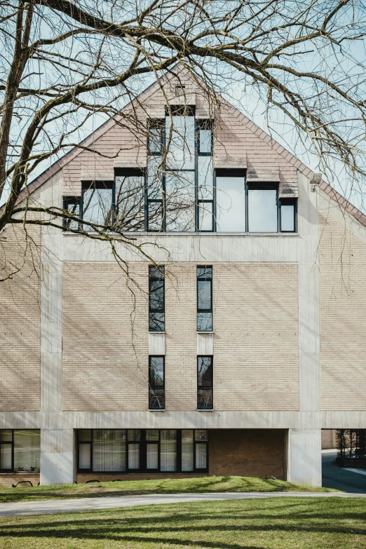 a building with trees and grass in the front