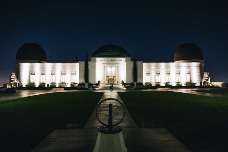 a dark picture of a large building with several domes on top