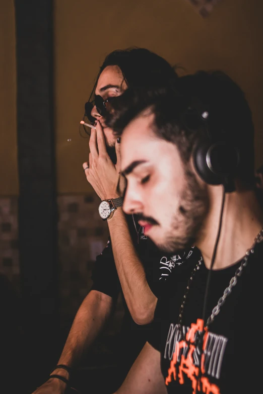 a man with headphones on sitting at a table