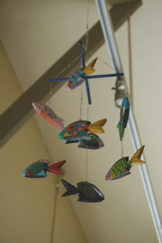 several colorful fish hang from an attached string
