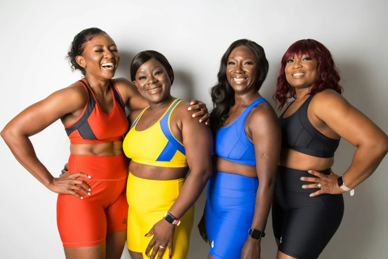 four women smiling in their sports outfits