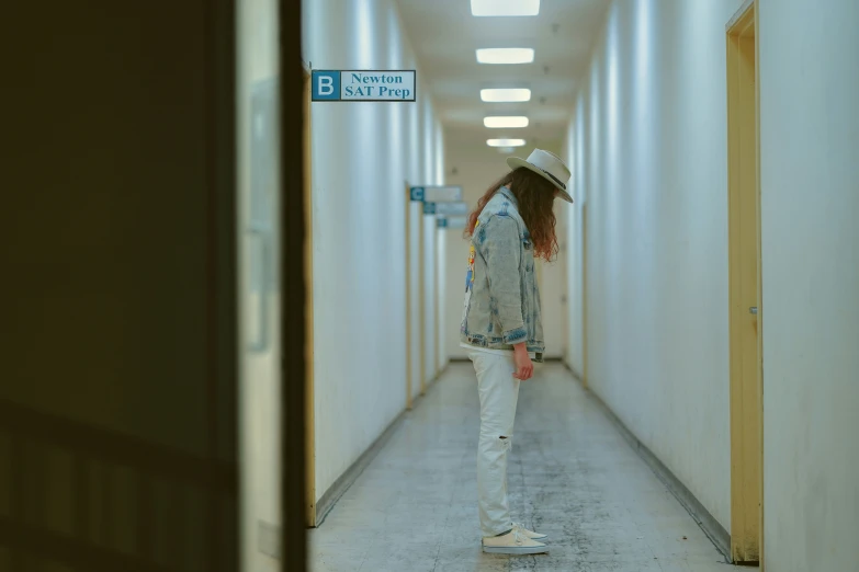 a person walking in the hallway with a hat on