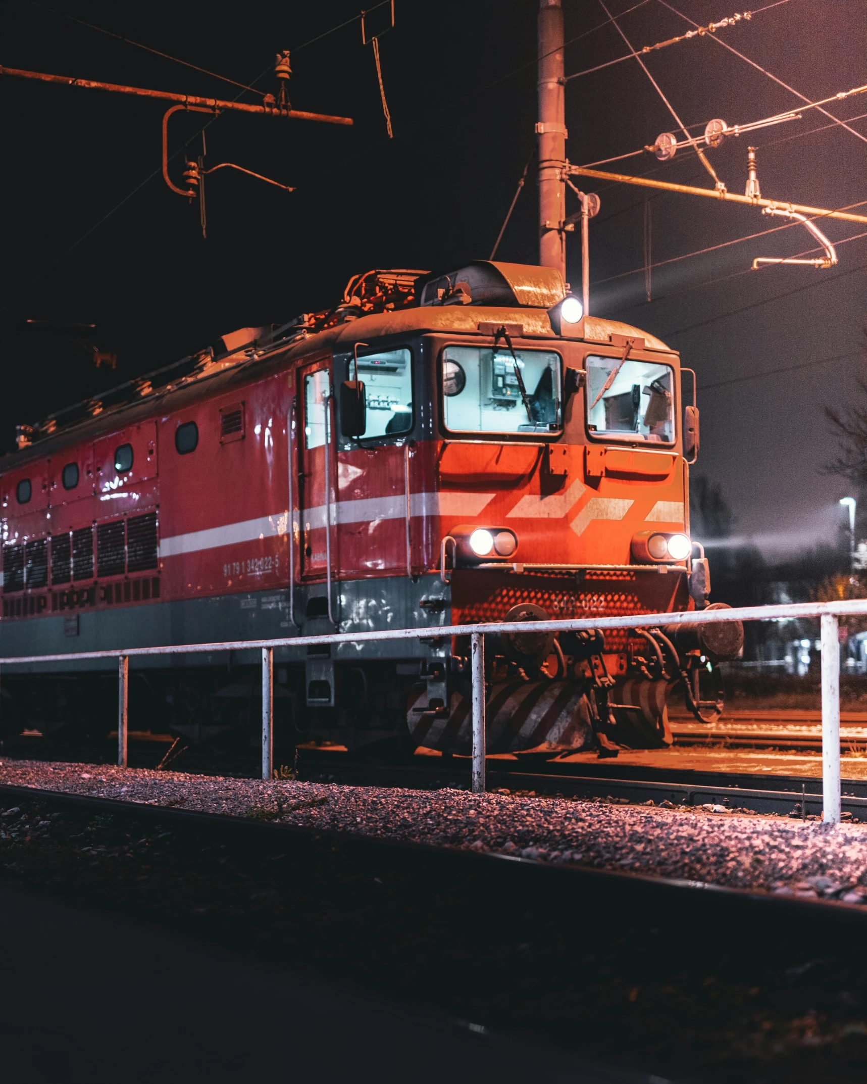 an orange train engine and its yellow cars